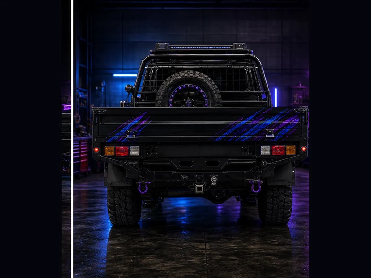 Back view of a Toyota LandCruiser 79 with Toyota badge and Wolfpack wrap